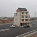 Residential House In The Middle Of Major Highway In China.